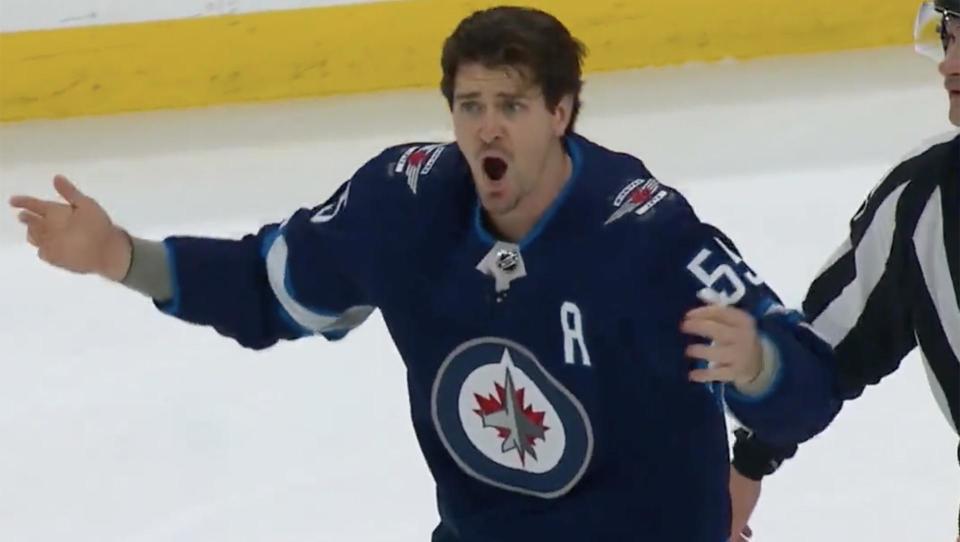 Winnipeg Jets forward Mark Scheifele attempts to pump up the crowd after dropping the gloves with Montreal Canadiens defenseman Chris Wideman. 