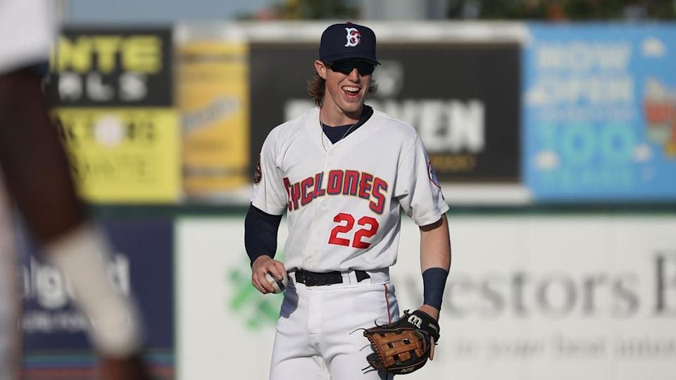 Mets prospect Brett Baty holding ball, smiling while playing for Brooklyn Cyclones