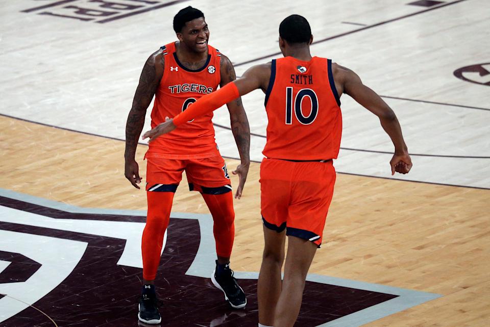 Auburn Tigers guard K.D. Johnson (0) reacts with forward Jabari Smith (10) after a basket against the Mississippi State Bulldogs in overtime at Humphrey Coliseum.