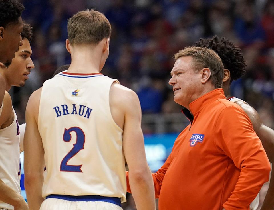 Kansas Jayhawks head coach Bill Self talks with players against the Texas Longhorns during the first half at Allen Fieldhouse.