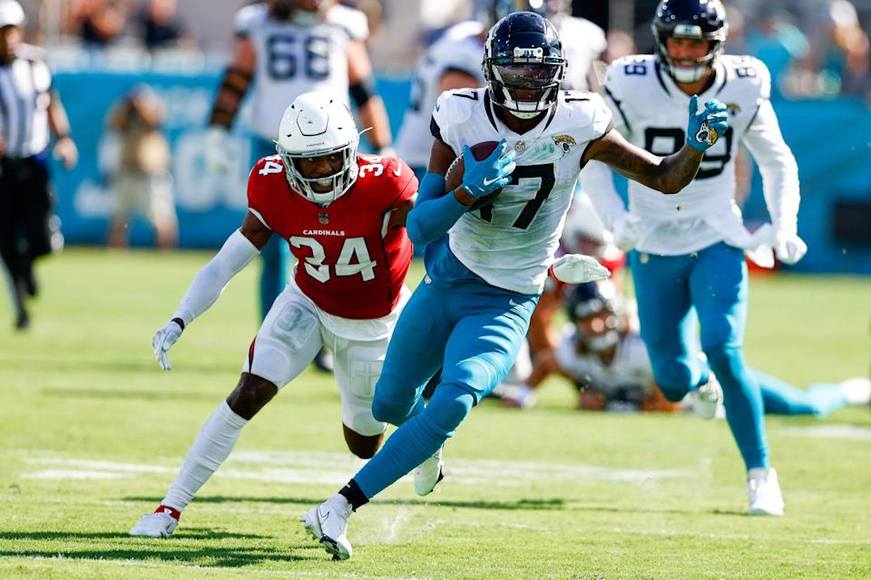 Jacksonville Jaguars wide receiver D.J. Chark (17) runs with the ball while being chased by Arizona Cardinals defensive back Jalen Thompson (34) in the fourth quarter at TIAA Bank Field.