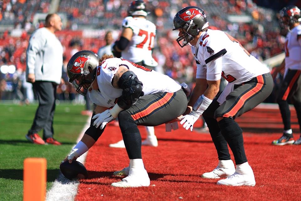 Tom Brady #12 of the Tampa Bay Buccaneers warms up with teammate Ryan Jensen #66 before the game against the Los Angeles Rams in the NFC Divisional Playoff game at Raymond James Stadium on January 23, 2022 in Tampa, Florida.