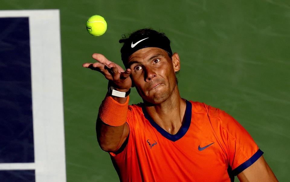 INDIAN WELLS, CALIFORNIA - MARCH 17: Rafael Nadal of Spain serves to Nick Kyrgios of Australia during the quarterfinals of the BNP Paribas Open at the Indian Wells Tennis Garden on March 17, 2022 in Indian Wells, California. (Photo by Matthew Stockman/Getty Images) - Matthew Stockman /Getty Images North America 