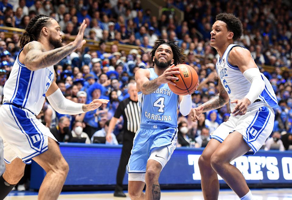 North Carolina guard RJ Davis (4) drives to the basket against Duke forward Paolo Banchero (5) during the first half at Cameron Indoor Stadium.