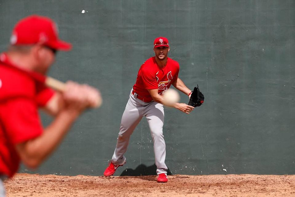 St. Louis Cardinals pitcher Jack Flaherty, right, works on fielding a ball hit back to him by bullpen coach Bryan Eversgerd during spring training baseball practice in 2020. On Tuesday, the Cardinals agreed to financial terms with five of their seven arbitration-eligible players, including the currently-injured Flaherty, who agreed to a $5 million contract.