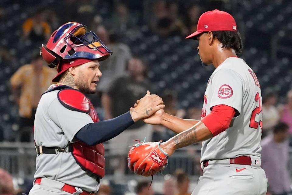 St. Louis Cardinals catcher Yadier Molina congratulates relief pitcher Alex Reyes after the team’s 4-3 win over the Pittsburgh Pirates last season. On Tuesday, the Cardinals agreed to financial terms with five of their seven arbitration-eligible players, including Reyes and fellow reliever Giovanny Gallegos.