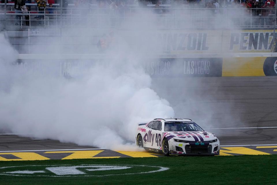 Alex Bowman (48) does a burnout after winning a NASCAR Cup Series auto race Sunday, March 6, 2022, in Las Vegas. (AP Photo/John Locher)