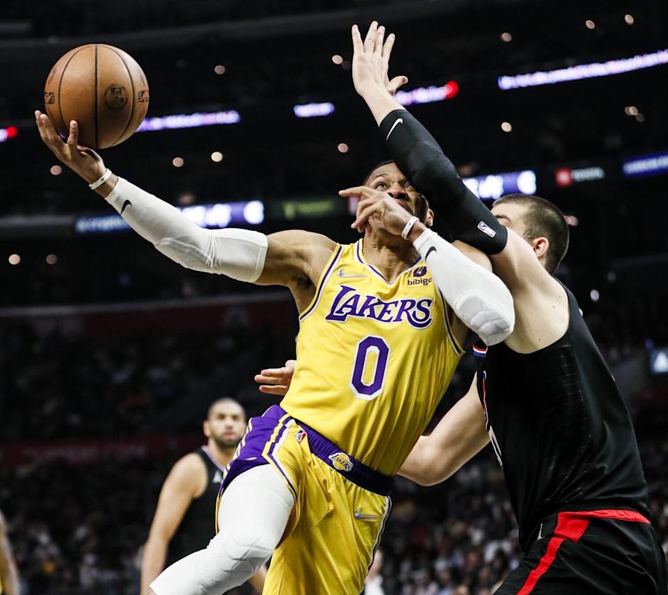 Lakers guard Russell Westbrook goes up for a shot while Clippers center Ivica Zubac defends.