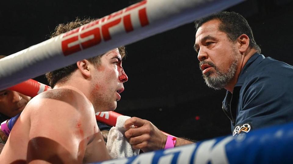 Richard Torrez Jr, left, sits in his corner while his father Richard Torrez dabs a cut on his forehead during his fight with Allen Melson at the Save Mart Center on Friday, March 4, 2022.