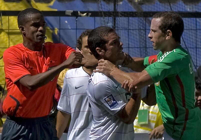 Mexico's Gerardo Torrado fights with American Benny Feilhaber during a FIFA World Cup qualifier at Estadio Azteca