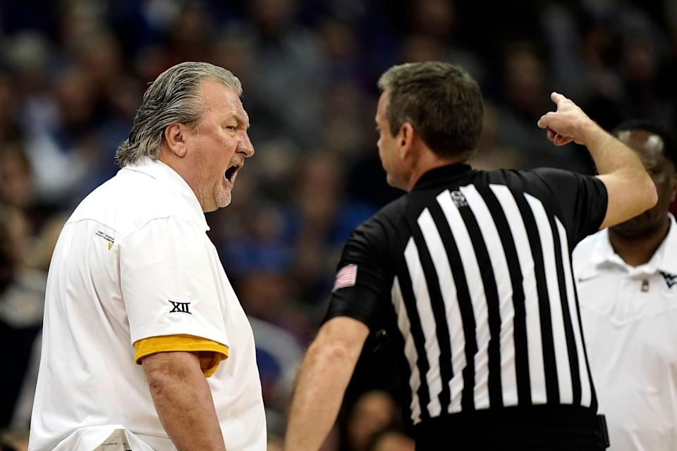 West Virginia head coach Bob Huggins talks to an official after being ejected from the game during the first half of an NCAA college basketball game against Kansas in the quarterfinal round of the Big 12 Conference tournament in Kansas City, Mo., Thursday, March 10, 2022. (AP Photo/Charlie Riedel)