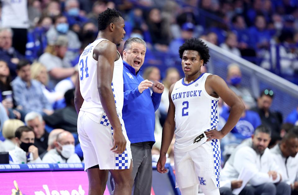 LEXINGTON, KENTUCKY - NOVEMBER 22: John Calipari the head coach of the Kentucky Wildcats gives instructions to Oscar Tshiebwe #4 and Sahvir Wheeler #2 during the game against the Albany Great Danes at Rupp Arena on November 22, 2021 in Lexington, Kentucky. (Photo by Andy Lyons/Getty Images)