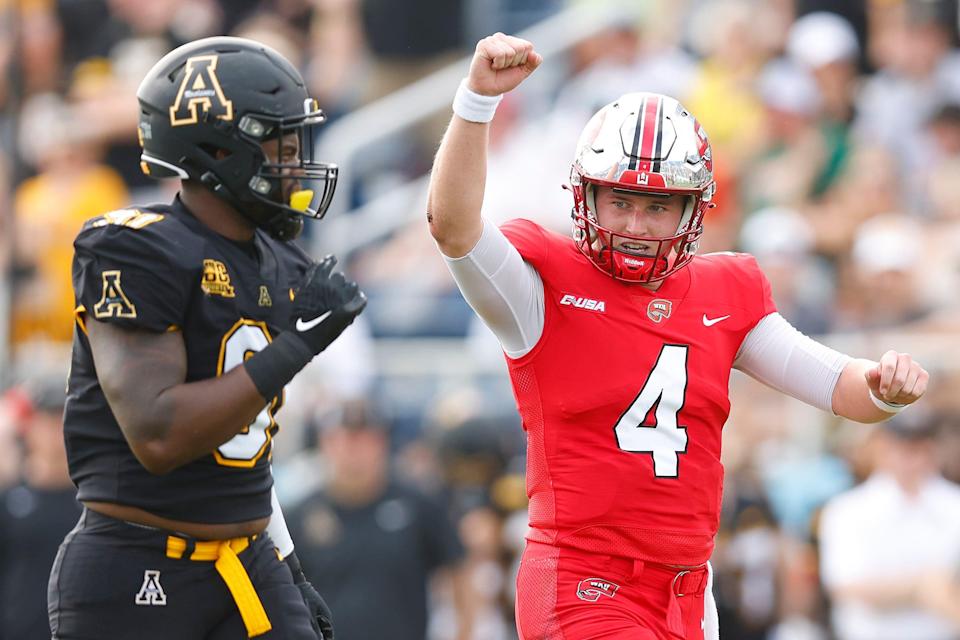 Bailey Zappe #4 of the Western Kentucky Hilltoppers celebrates after throwing a five-yard touchdown pass to Joey Beljan #89 (not pictured) against the Appalachian State Mountaineers during the first half of the RoofClaim.com Boca Raton Bowl at FAU Stadium on December 18, 2021 in Boca Raton, Florida.