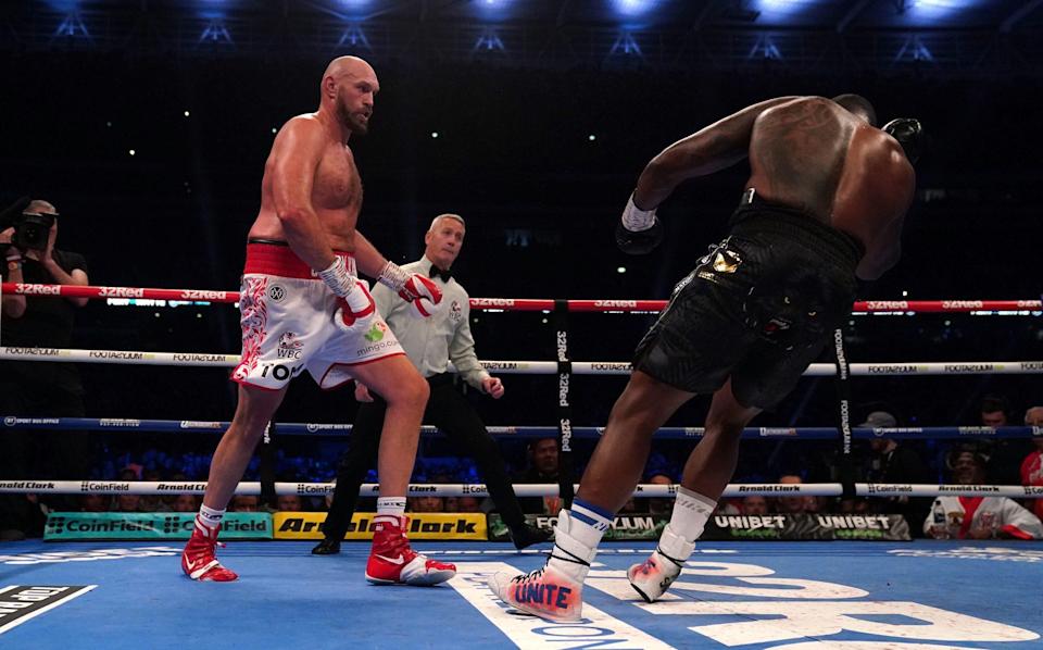 Whyte falls to the canvas after Fury landed the uppercut - PA