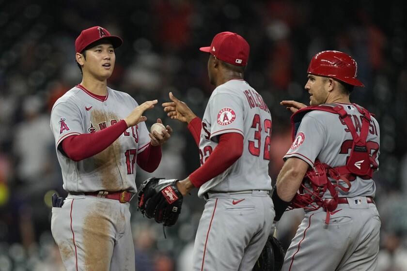 Los Angeles Angels' Shohei Ohtani (17) Raisel Iglesias (32) and Max Stassi (33) celebrate.