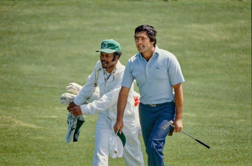 Seve Ballesteros and caddie Marion Herrington walk up the 18th fairway during the final round of the 1980 Masters.