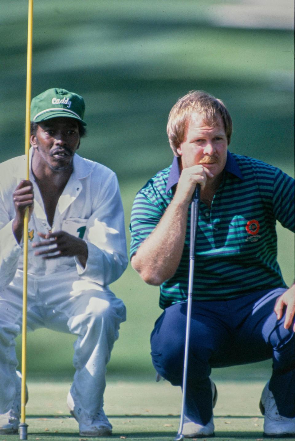 Craig Stadler and caddie Ben Bussey line up a putt in the opening round of the 1982 Masters.