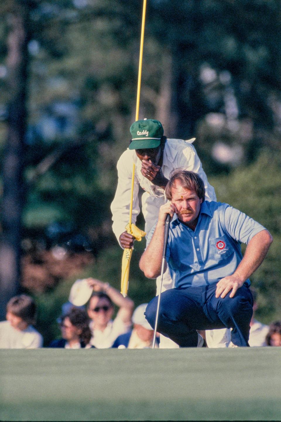 Craig Stadler and his caddie Ben Bussey line up putt at the 1982 Masters.