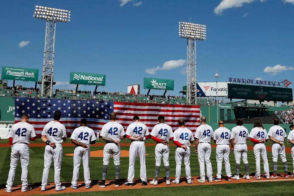 The Boston Red Sox line up on the first-base line wearing No. 42 in honor of Jackie Robinson before Friday's home opener against the Minnesota Twins.