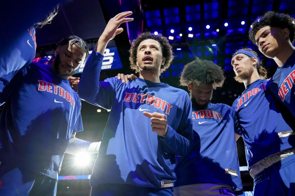 Cade Cunningham, middle, talks with his Detroit Pistons teammates in a huddle before a game against the Philadelphia 76ers on March 31, 2022. (Nic Antaya/Getty Images)