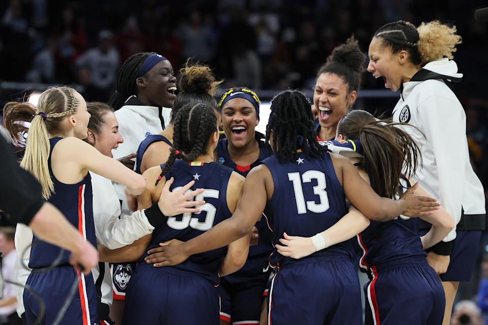 The UConn Huskies celebrate after defeating Stanford the 2022 NCAA women's Final Four semifinal on April 1, 2022 at Target Center in Minneapolis. (Andy Lyons/Getty Images)