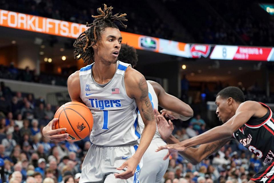 Memphis' Emoni Bates (1) grabs a rebound in the first half of an NCAA college basketball game against Western Kentucky, Friday, Nov. 19, 2021, in Memphis, Tenn. (AP Photo/Karen Pulfer Focht)