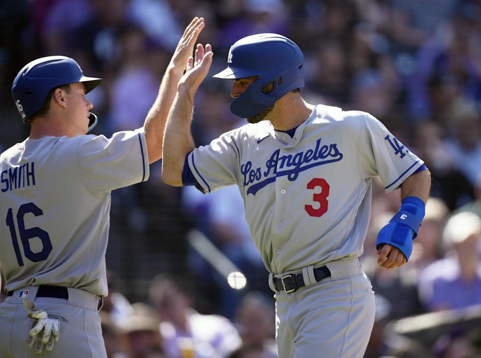 Will Smith, left, congratulates Chris Taylor after they scored on Gavin Lux's single in a five-run fourth inning.