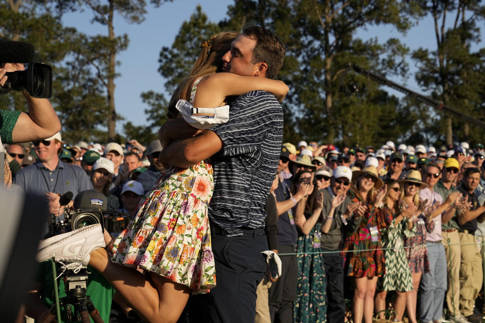 Scottie Scheffler lifts his wife Meredith Scudder off her feet after winning the 86th Masters golf tournament on Sunday, April 10, 2022, in Augusta, Ga. (AP Photo/David J. Phillip)