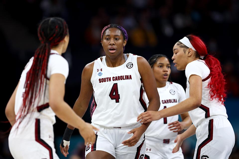 MINNEAPOLIS, MINNESOTA - APRIL 01: Aliyah Boston #4 of the South Carolina Gamecocks reacts with teammates in the first quarter against the Louisville Cardinals during the 2022 NCAA Women's Final Four semifinal game at Target Center on April 01, 2022 in Minneapolis, Minnesota. (Photo by Elsa/Getty Images)