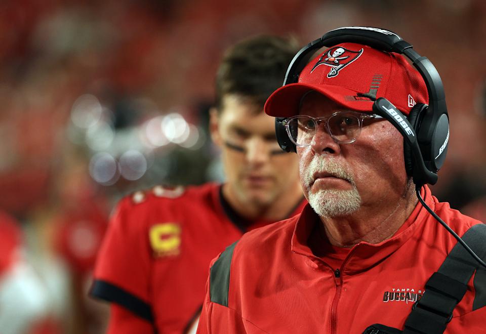 TAMPA, FLORIDA - DECEMBER 19: Head coach Bruce Arians and quarterback Tom Brady #12 of the Tampa Bay Buccaneers watch from the sidelines during the game against the New Orleans Saints at Raymond James Stadium on December 19, 2021 in Tampa, Florida. (Photo by Mike Ehrmann/Getty Images)