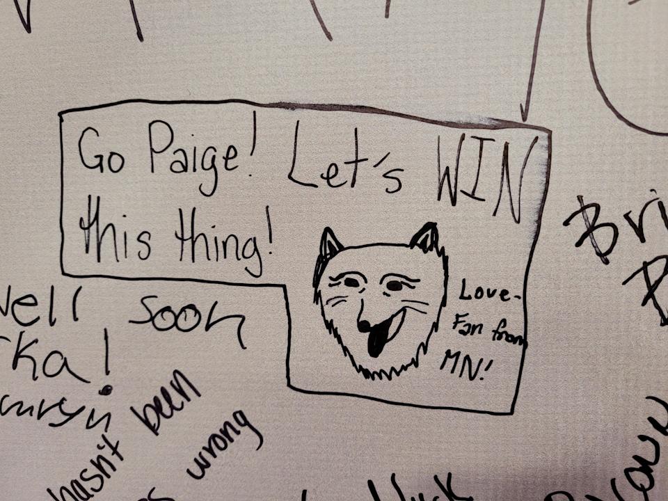 A fan signs the UConn Huskies poster, cheering on hometown Paige Bueckers. (Cassandra Negley/Yahoo Sports)