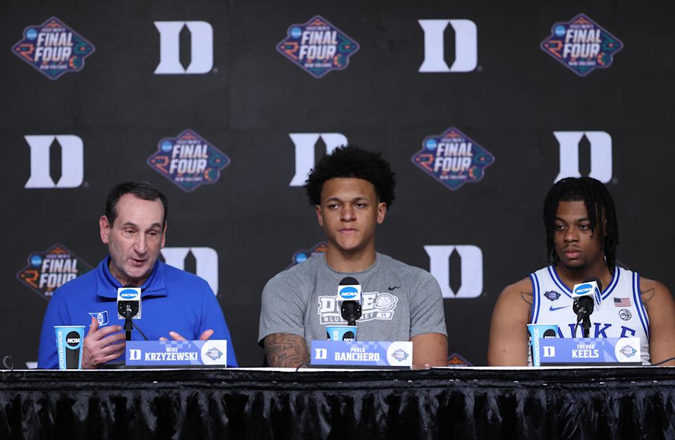 NEW ORLEANS, LOUISIANA - APRIL 02: Head coach Mike Krzyzewski of the Duke Blue Devils talks to the press as Paolo Banchero #5 and Trevor Keels #1 look on after losing to the North Carolina Tar Heels 81-77 in the 2022 NCAA Men's Basketball Tournament Final Four semifinal at Caesars Superdome on April 02, 2022 in New Orleans, Louisiana. (Photo by Tom Pennington/Getty Images)