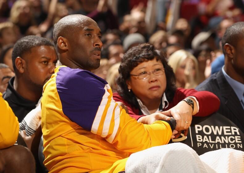 Kobe Bryant #24 of the Los Angeles Lakers has his wrist massaged by the Lakers' Director of Physical Therapy, Dr. Judy Seto,