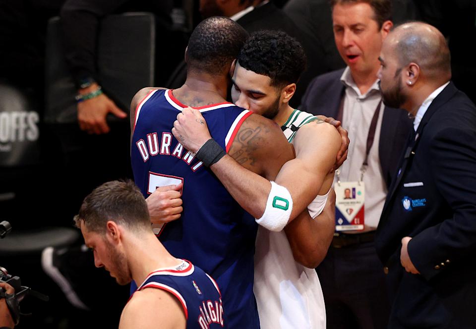 Brooklyn's Kevin Durant embraces and congratulates Boston's Jayson Tatum after the Celtics swept the Nets in the first round of the NBA playoffs on April 25, 2022. (Elsa/Getty Images)