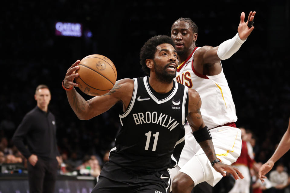 NEW YORK, NEW YORK - APRIL 12: Kyrie Irving #11 of the Brooklyn Nets dribbles as Caris LeVert #3 of the Cleveland Cavaliers defends during the first half of the Eastern Conference 2022 Play-In Tournament at Barclays Center on April 12, 2022 in the Brooklyn borough of New York City. NOTE TO USER: User expressly acknowledges and agrees that, by downloading and or using this photograph, User is consenting to the terms and conditions of the Getty Images License Agreement. (Photo by Sarah Stier/Getty Images)