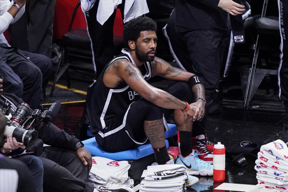 Brooklyn Nets guard Kyrie Irving sits on the baseline during their NBA playoffs first-round series against the Boston Celtics. The Celtics swept the Nets. (AP Photo/John Minchillo)