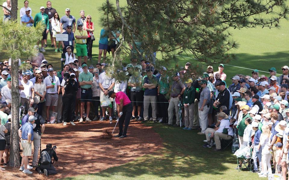 Tiger Woods plays his shot on the ninth hole during the first round of the Masters - Getty Images