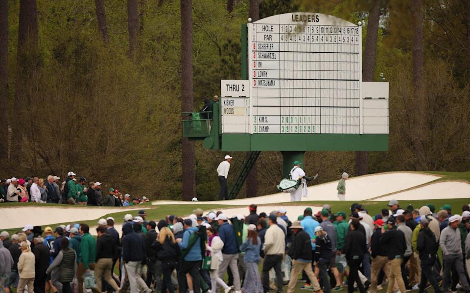 Tiger Woods under the a leaderboard on the 3rd green - REUTERS/Brian Snyder