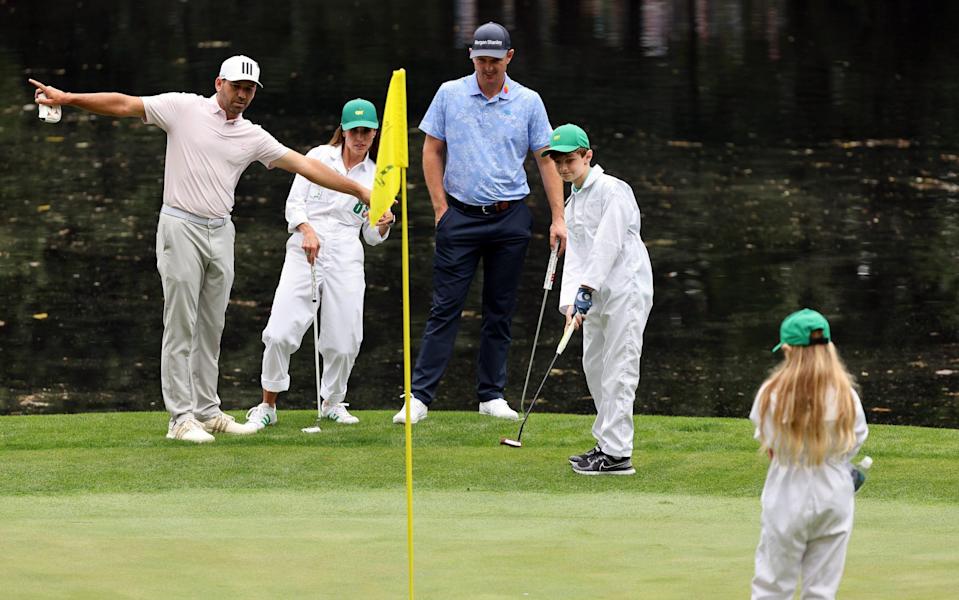 Sergio Garcia of Spain, wife Angela Garcia and Justin Rose of England during the Par Three Contest prior to the Masters at Augusta National Golf Club on April 06, 2022 in Augusta, Georgia - GETTY IMAGES