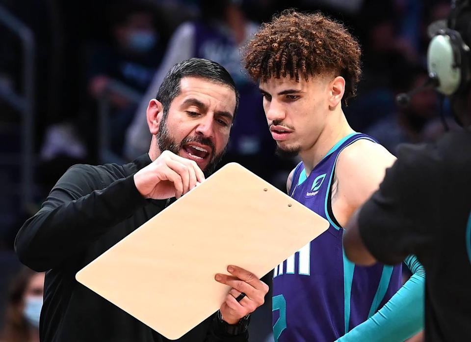 Charlotte Hornets head coach James Borrego goes over a play with guard LaMelo Ball in 2021.