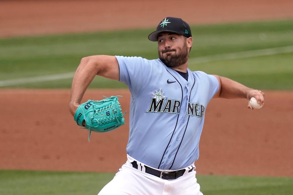 Seattle Mariners starting pitcher Robbie Ray throws during the first inning of a spring training baseball game against the Texas Rangers Monday, March 28, 2022, in Peoria, Ariz. (AP Photo/Charlie Riedel)