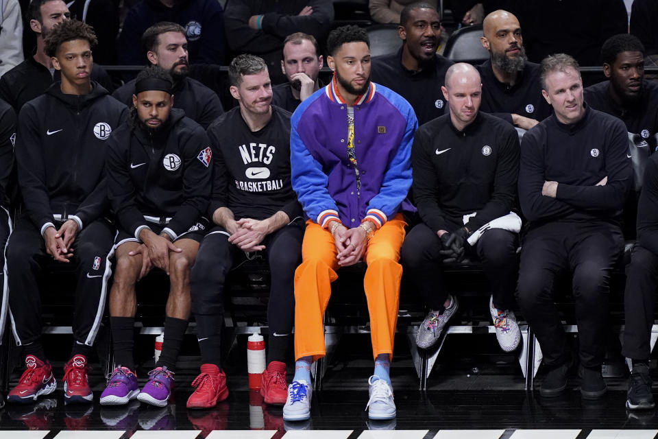 Brooklyn Nets' Ben Simmons, center, sits on the bench during Game 3 of their irst-round playoff series against the Boston Celtics. Simmons did not play this season. (AP Photo/John Minchillo)