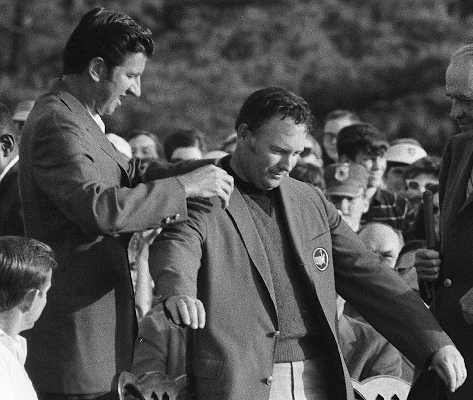 Masters champion Billy Casper (right) receives his green jacket from defending champion winner George Archer at Augusta National Golf Club in 1970.