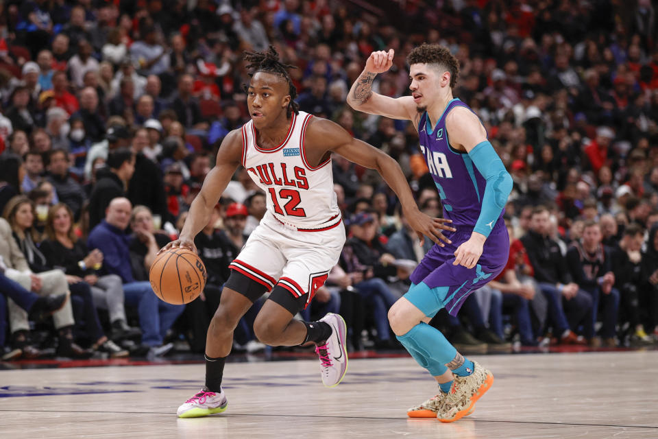 Chicago Bulls rookie guard Ayo Dosunmu drives to the basket against Charlotte Hornets guard LaMelo Ball this season. (Kamil Krzaczynski/USA TODAY Sports)