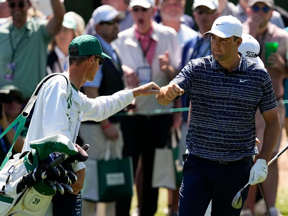 Scottie Scheffler and caddie Ted Scott celebrate a chip-in birdie at Augusta National.