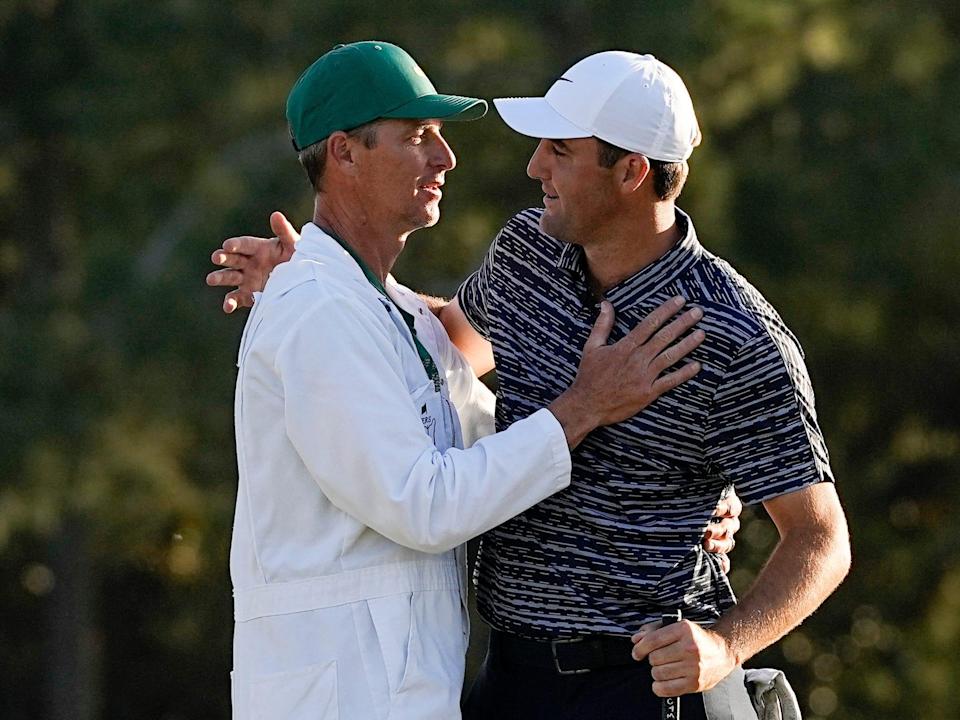 Scottie Scheffler and caddie Ted Scott celebrate their win at the Masters.