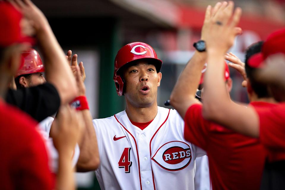 Cincinnati Reds left fielder Shogo Akiyama (4) celebrates with teammates after scoring on a Cincinnati Reds shortstop Kyle Farmer (17) double in the second inning of the MLB baseball game between Cincinnati Reds and Milwaukee Brewers on Saturday, July 17, 2021, at Great American Ball Park. 