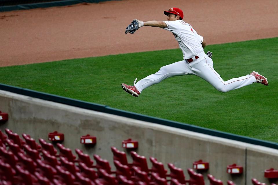 Cincinnati Reds left fielder Shogo Akiyama (4) makes a leaping catch on a line drive off the bat of Pittsburgh Pirates left fielder Bryan Reynolds (10) in the seventh inning of the MLB National League game between the Cincinnati Reds and the Pittsburgh Pirates at Great American Ball Park in downtown Cincinnati on Thursday, Aug. 13, 2020. The Pirates kept the lead, winning 9-6.