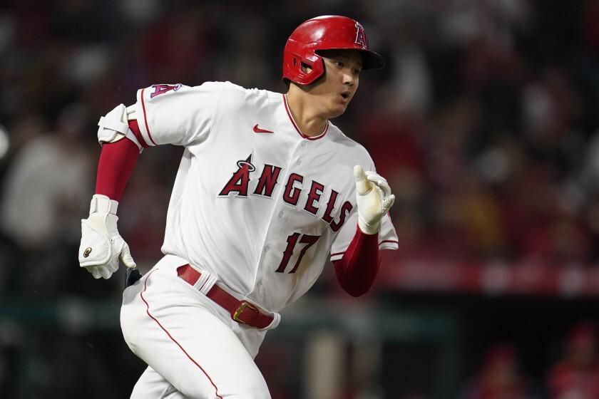 Los Angeles Angels' Shohei Ohtani rounds first base as he drives in a run with a double during the sixth inning of the team's baseball game against the Cleveland Guardians on Wednesday, April 27, 2022, in Anaheim, Calif. (AP Photo/Marcio Jose Sanchez)