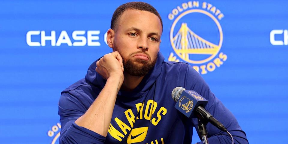 Stephen Curry frowns during a press conference in 2022.